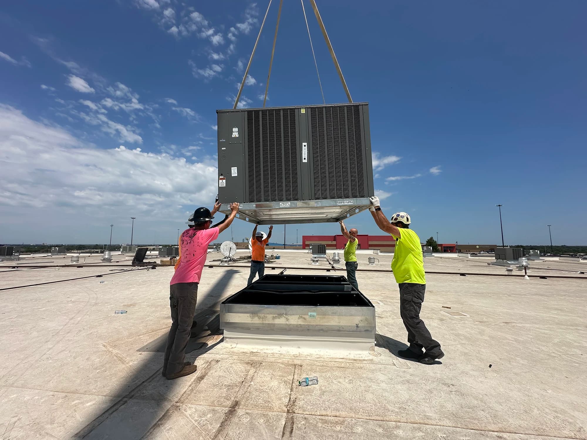 RCI crew craning a new rooftop HVAC unit into place on an Oklahoma commercial building
