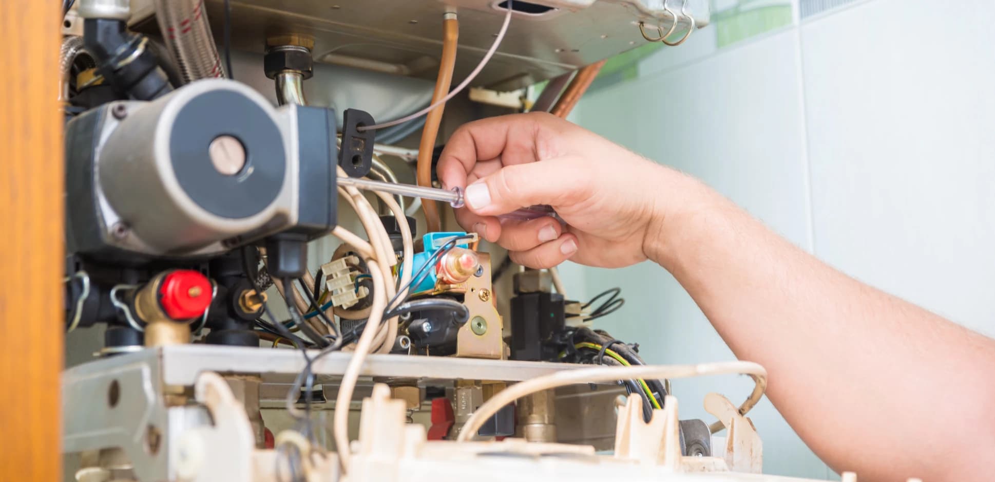Technician inspecting the burner compartment of an open gas furnace